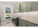 Bright laundry room with shaker cabinets, granite countertop, and a window at 291 Riverstone Dr, Pittsboro, NC 27312