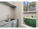 Laundry room with farmhouse sink, green cabinets, and backyard view at 291 Riverstone Dr, Pittsboro, NC 27312