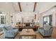 Living area with exposed beams, hardwood floors, and view of the kitchen at 291 Riverstone Dr, Pittsboro, NC 27312