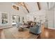 Spacious living room with exposed beams, hardwood floors, and access to the backyard at 291 Riverstone Dr, Pittsboro, NC 27312
