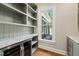 Spacious pantry with open shelving, granite countertop and wine cooler at 291 Riverstone Dr, Pittsboro, NC 27312