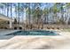 Stunning pool with stone features and lush landscaping at 291 Riverstone Dr, Pittsboro, NC 27312
