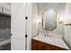 Powder room with marble vanity, gold mirror, and tropical wallpaper at 291 Riverstone Dr, Pittsboro, NC 27312