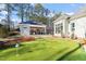 Private putting green adjacent to pool and patio at 291 Riverstone Dr, Pittsboro, NC 27312
