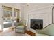 Relaxing sitting area with fireplace and pool access at 291 Riverstone Dr, Pittsboro, NC 27312