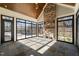 Sunroom with fireplace, stone flooring and access to pool at 291 Riverstone Dr, Pittsboro, NC 27312