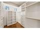 Large walk-in closet with window, shelves and hanging rods at 291 Riverstone Dr, Pittsboro, NC 27312
