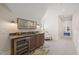 Elegant wet bar with granite countertop, wine cooler, and seating area at 291 Riverstone Dr, Pittsboro, NC 27312