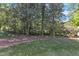 Spacious backyard with mature trees providing ample shade and privacy at 2601 Mayview Rd, Raleigh, NC 27607