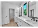 Bright bathroom features double vanity, white countertops, and black hardware accents at 2601 Mayview Rd, Raleigh, NC 27607