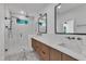 Modern bathroom with a walk-in shower, double vanity, and white marble countertops at 2601 Mayview Rd, Raleigh, NC 27607