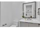 A half bathroom with a gray vanity and modern fixtures at 2601 Mayview Rd, Raleigh, NC 27607