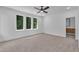 Light-filled bedroom featuring a ceiling fan and an ensuite bathroom at 2601 Mayview Rd, Raleigh, NC 27607