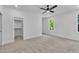 Spacious bedroom with walk-in closet, carpet floors, and a bright window view at 2601 Mayview Rd, Raleigh, NC 27607