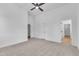 Large bedroom with ceiling fan, carpet floors, and multiple doors leading to other rooms at 2601 Mayview Rd, Raleigh, NC 27607
