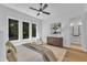 Bright bedroom with three windows overlooking a wooded area and a wooden dresser at 2601 Mayview Rd, Raleigh, NC 27607