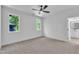 Bedroom with natural light, ceiling fan, carpet floors, and easy access to the bathroom at 2601 Mayview Rd, Raleigh, NC 27607