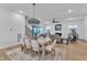 Elegant dining area with a table set for six, opening to a living room with cozy seating and fireplace at 2601 Mayview Rd, Raleigh, NC 27607