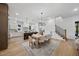 Open concept dining area with light wood table and access to kitchen at 2601 Mayview Rd, Raleigh, NC 27607