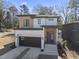 Modern two-story home with dark garage door and light-colored siding at 2601 Mayview Rd, Raleigh, NC 27607