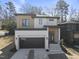 Modern two-story home with dark garage door and light-colored siding at 2601 Mayview Rd, Raleigh, NC 27607