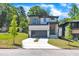 Striking modern home with a two-car garage, sleek gray door, manicured lawn, and a blend of textures on the facade at 2601 Mayview Rd, Raleigh, NC 27607