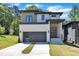 Contemporary home featuring modern design, well-manicured lawn, and a paved driveway at 2601 Mayview Rd, Raleigh, NC 27607