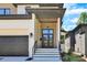 Contemporary home entrance showcasing stylish door, porch and attached garage at 2601 Mayview Rd, Raleigh, NC 27607
