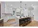 Modern kitchen with island, white cabinets, and marble countertops at 2601 Mayview Rd, Raleigh, NC 27607