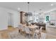 Open-concept kitchen with large island and stainless appliances, connected to a dining area with a modern chandelier at 2601 Mayview Rd, Raleigh, NC 27607