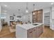 Open-concept kitchen with a large island, seating, and an adjacent dining area, offering seamless flow to the living room at 2601 Mayview Rd, Raleigh, NC 27607