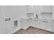 Laundry room boasts cabinets, counter space, sink, and hexagon tile flooring at 2601 Mayview Rd, Raleigh, NC 27607