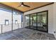 Inviting screened-in patio features stone flooring, ceiling fan, and sliding glass doors at 2601 Mayview Rd, Raleigh, NC 27607