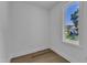 Bright room with hardwood floors features a large window with views of an adjacent home at 2601 Mayview Rd, Raleigh, NC 27607
