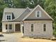 Charming exterior elevation featuring stone accents and a beautifully designed roofline at 57 Hazelwood, Pittsboro, NC 27312