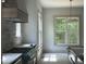 Gourmet kitchen features stainless steel appliances, ample counter space, and a stylish range hood at 57 Hazelwood, Pittsboro, NC 27312