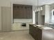 Modern kitchen with custom cabinetry, stainless steel appliances, and a center island for food preparation at 57 Hazelwood, Pittsboro, NC 27312