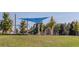 Community playground area featuring a shaded play structure and swings, perfect for families at 57 Hazelwood, Pittsboro, NC 27312