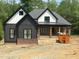Stunning new construction home with a modern farmhouse design, featuring gray siding and brick accents at 72 Hazelwood, Pittsboro, NC 27312