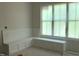 Bright interior nook featuring custom built in seating and a large window with natural light at 72 Hazelwood, Pittsboro, NC 27312
