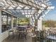 A beautifully designed outdoor patio with iron seating underneath a pergola at 72 Hazelwood, Pittsboro, NC 27312