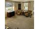 Living room with two armchairs, a TV, and large windows at 3418 Leonard St, Raleigh, NC 27607