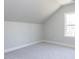 Finished attic with carpet and a window for natural light at 167 Edgefield St, Pittsboro, NC 27312