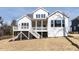 Stunning back exterior with a porch, second-story deck, and steps down to the yard at 167 Edgefield St, Pittsboro, NC 27312