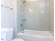 Modern bathroom showcasing a tub/shower combination and gray tiled walls at 167 Edgefield St, Pittsboro, NC 27312