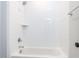 White tiled shower and tub combination, with a chrome shower head and fixtures at 167 Edgefield St, Pittsboro, NC 27312