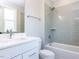 Modern bathroom showcasing a tub/shower combination and vanity with white cabinets at 167 Edgefield St, Pittsboro, NC 27312