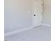 Clean bedroom with plush carpeting, white trim, and a solid-core door at 167 Edgefield St, Pittsboro, NC 27312
