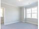 Bright bedroom showcasing large windows, neutral walls, and cozy carpet flooring at 167 Edgefield St, Pittsboro, NC 27312