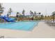 Community swimming pool with a slide and many lounge chairs at 167 Edgefield St, Pittsboro, NC 27312